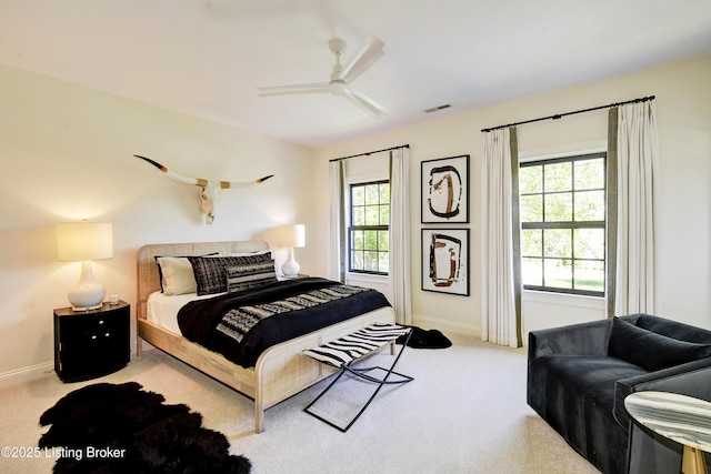 carpeted bedroom featuring baseboards and ceiling fan