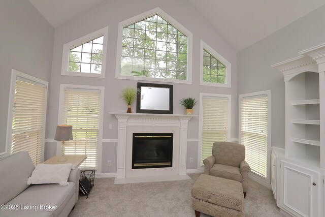 6211 Perrin, Crestwood, KY 40014 - living area featuring high vaulted ceiling, a fireplace with flush hearth, light carpet, built in shelves, and baseboards