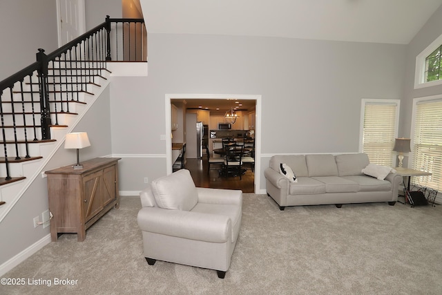 6211 Perrin, Crestwood, KY 40014 - living area with a towering ceiling, stairway, light carpet, baseboards, and a chandelier