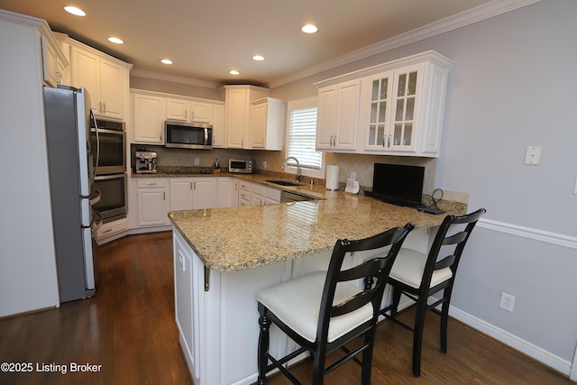 6211 Perrin, Crestwood, KY 40014 - kitchen featuring appliances with stainless steel finishes, a peninsula, crown molding, a sink, and white cabinets