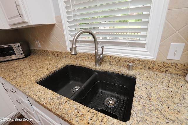 6211 Perrin, Crestwood, KY 40014 - kitchen view of a sink, backsplash, white cabinets, and light stone counters