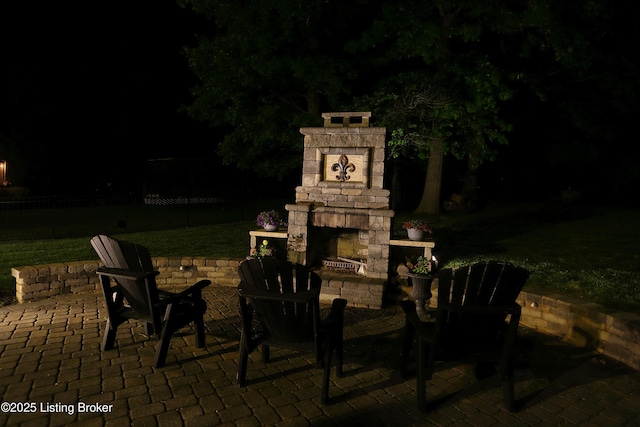 6211 Perrin, Crestwood, KY 40014 - patio at twilight featuring exterior fireplace and a lawn