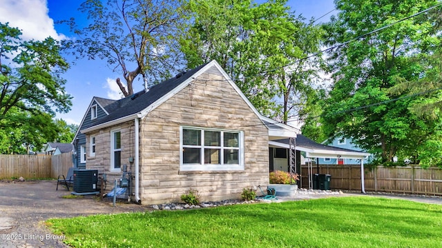 rear view of property with central AC
