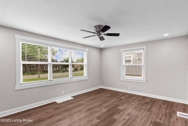 spare room featuring wood finished floors, baseboards, ceiling fan, and recessed lighting