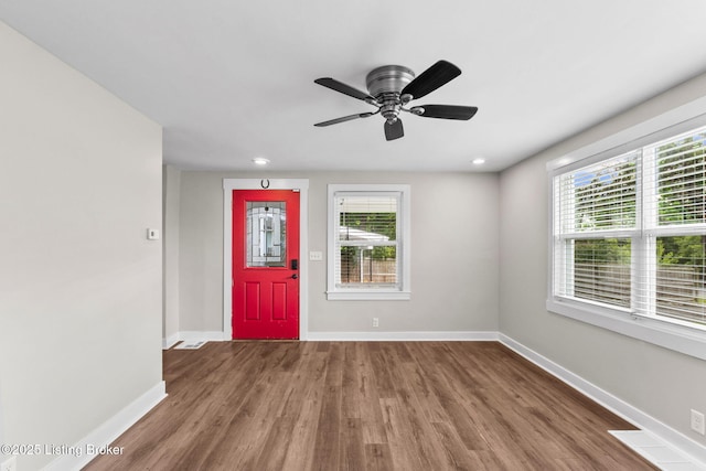 foyer with wood finished floors, baseboards, and a ceiling fan