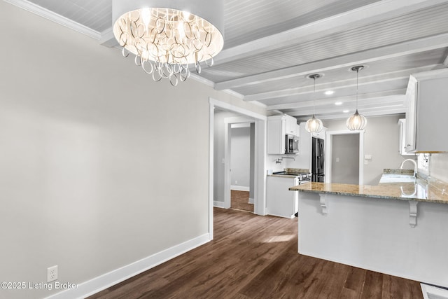 kitchen featuring stainless steel appliances, a kitchen bar, beamed ceiling, dark wood-type flooring, and white cabinetry
