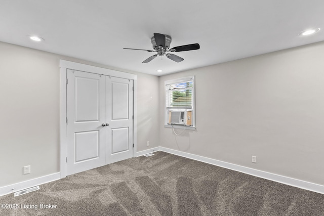 unfurnished bedroom with dark colored carpet, baseboards, recessed lighting, ceiling fan, and a closet
