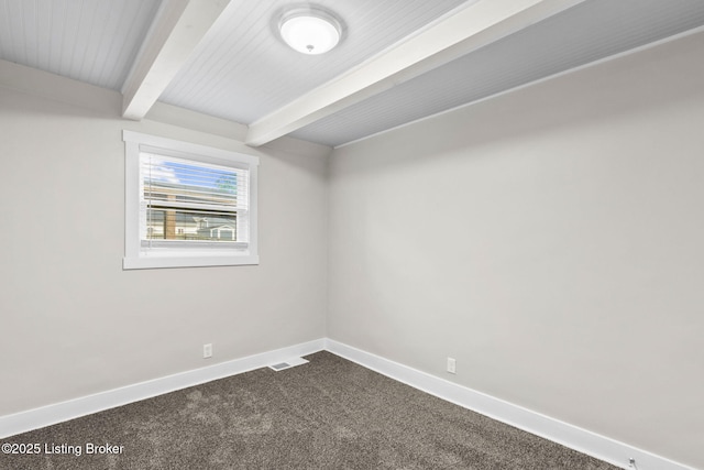 unfurnished room with beam ceiling, dark carpet, and baseboards