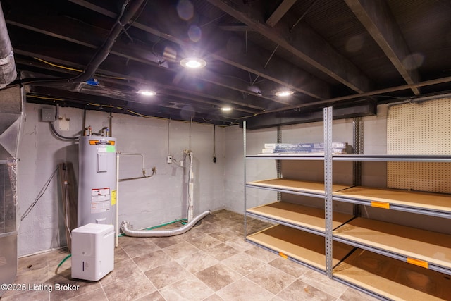 unfinished basement featuring electric water heater