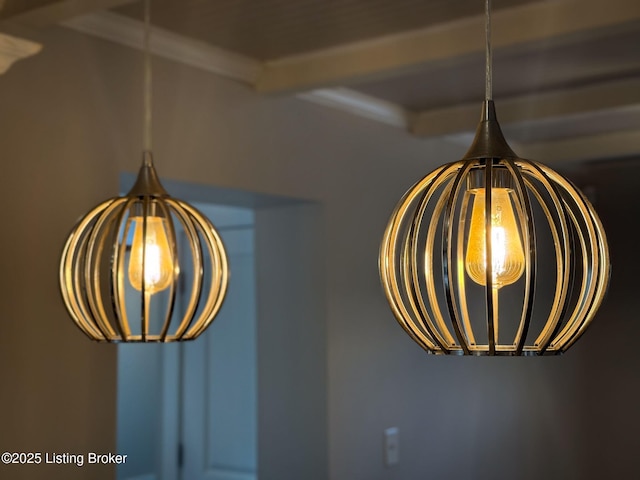 detailed view of a chandelier and beam ceiling