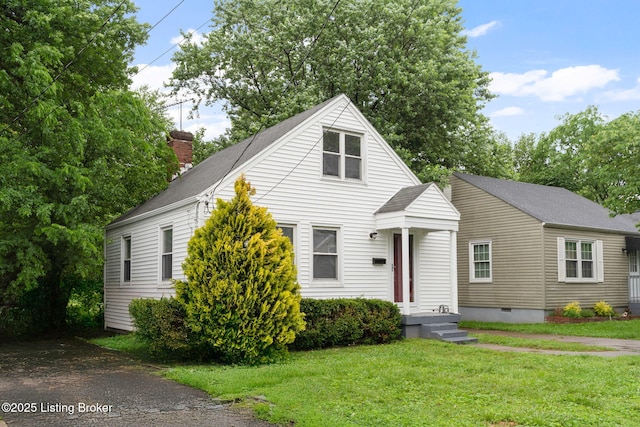 1119 Carlisle Ave, Louisville, KY 40215 - view of front of home with a front yard, a shingled roof, and a chimney