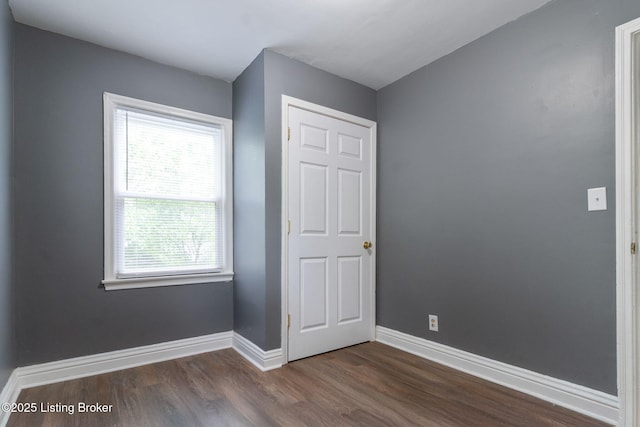 1119 Carlisle Ave, Louisville, KY 40215 - unfurnished bedroom featuring dark wood-style floors and baseboards