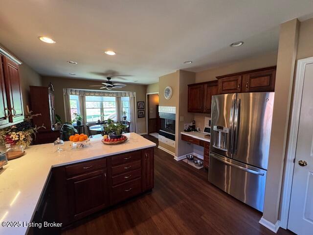 10606 Black Iron Rd, Louisville, KY 40291 - kitchen featuring stainless steel fridge, dark wood finished floors, light countertops, a peninsula, and recessed lighting
