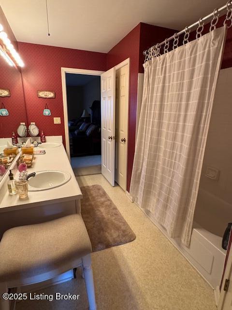 10606 Black Iron Rd, Louisville, KY 40291 - bathroom featuring double vanity and shower / bath combination with curtain