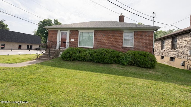 3410 Dixie Hwy, Louisville, KY 40216 - view of front of house with a front lawn, a chimney, and brick siding