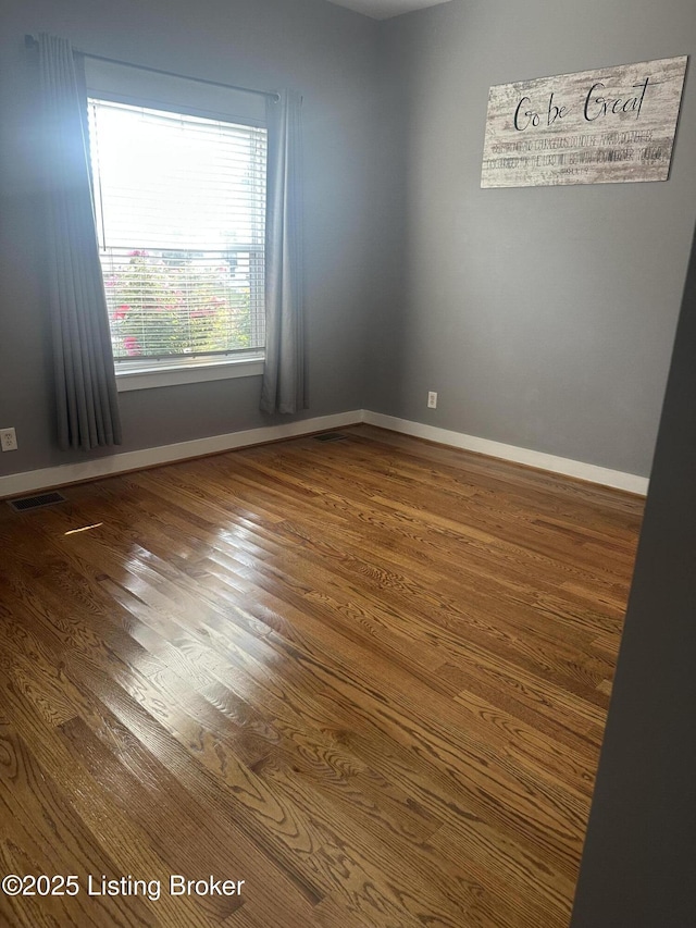 827 Mulberry St, Louisville, KY 40217 - empty room featuring wood finished floors and baseboards