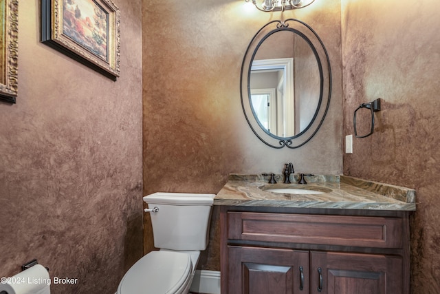 bathroom featuring toilet and vanity