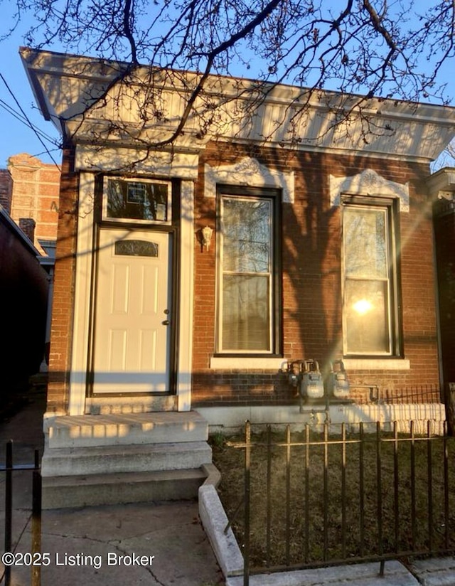 doorway to property with brick siding