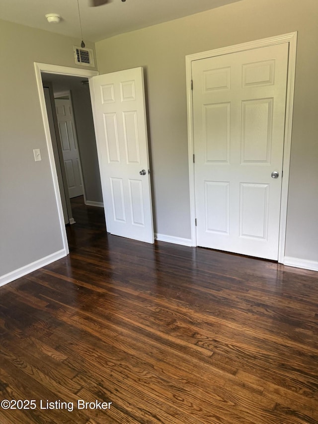254 Greenbriar Ln, Louisville, KY 40229 - unfurnished bedroom featuring baseboards and dark wood-style flooring