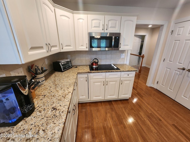 7201 Creekton Dr, Louisville, KY 40241 - kitchen with stainless steel microwave, white cabinets, and tasteful backsplash