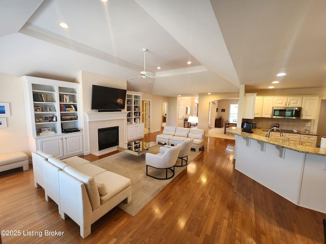 7201 Creekton Dr, Louisville, KY 40241 - living area featuring a raised ceiling, hardwood / wood-style flooring, a tile fireplace, recessed lighting, and a ceiling fan