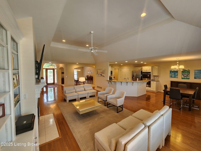 7201 Creekton Dr, Louisville, KY 40241 - living room with arched walkways, wood-type flooring, lofted ceiling, recessed lighting, and a chandelier