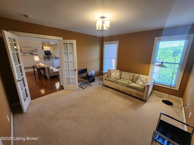 7201 Creekton Dr, Louisville, KY 40241 - carpeted living room with baseboards and a chandelier
