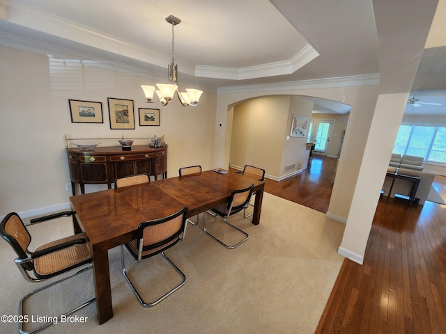 7201 Creekton Dr, Louisville, KY 40241 - dining space with arched walkways, hardwood / wood-style floors, ornamental molding, a chandelier, and a tray ceiling