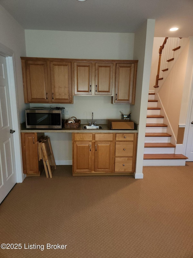 7201 Creekton Dr, Louisville, KY 40241 - kitchen with stainless steel microwave, a sink, light colored carpet, and brown cabinets