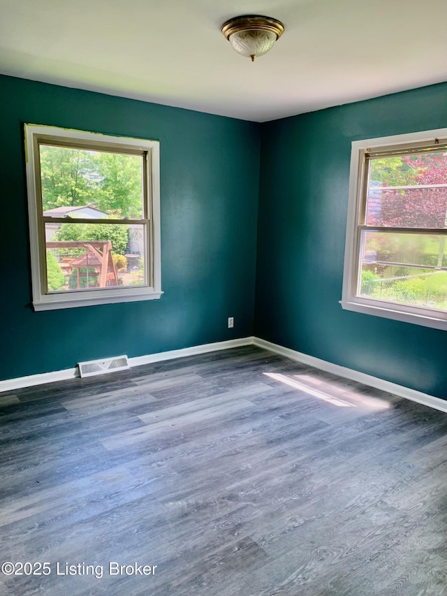 4727 Cliff Ave, Louisville, KY 40215 - empty room with plenty of natural light, wood finished floors, and baseboards