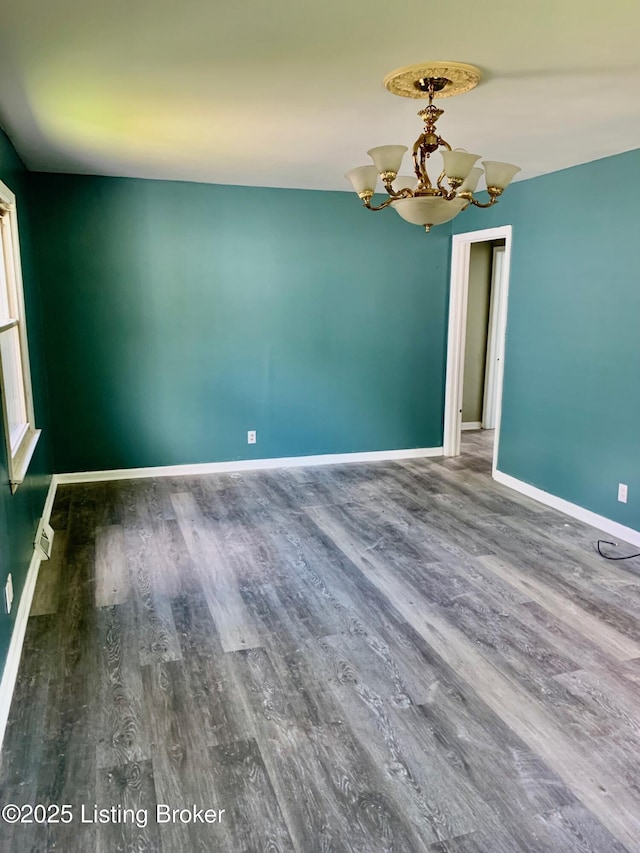 4727 Cliff Ave, Louisville, KY 40215 - empty room with a chandelier, wood finished floors, and baseboards