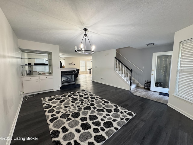 8005 Grandmeadow Ln, Louisville, KY 40258 - foyer featuring stairs, baseboards, a chandelier, dark wood-style floors, and a textured ceiling