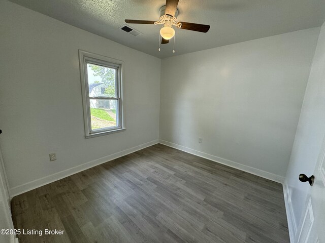 76 Bethel Church Rd, Brandenburg, KY 40108 - unfurnished room with ceiling fan, dark wood finished floors, baseboards, and a textured ceiling