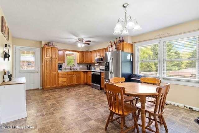 8887 New Haven Rd, New Haven, KY 40051 - kitchen with stainless steel appliances, light countertops, a sink, a chandelier, and ceiling fan