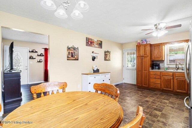 8887 New Haven Rd, New Haven, KY 40051 - dining area featuring ceiling fan, a chandelier, stone finish floors, and baseboards
