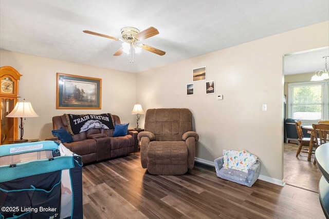 8887 New Haven Rd, New Haven, KY 40051 - living room featuring a ceiling fan, wood finished floors, baseboards, and a chandelier