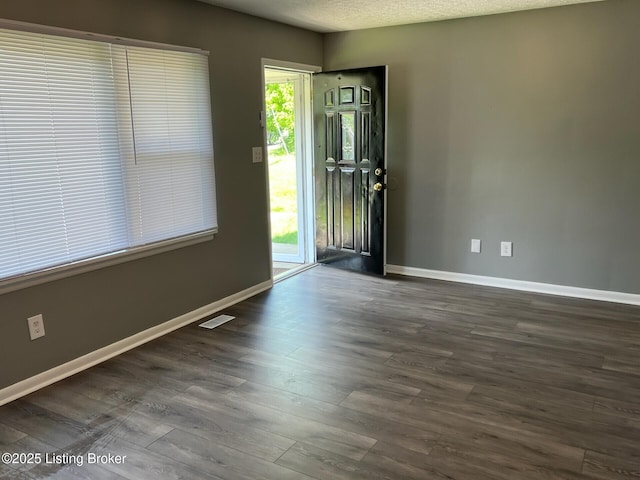 1644 Huntoon Ave, Louisville, KY 40215 - spare room featuring baseboards and dark wood-style flooring