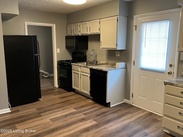 1644 Huntoon Ave, Louisville, KY 40215 - kitchen featuring black appliances, a sink, wood finished floors, baseboards, and a textured ceiling