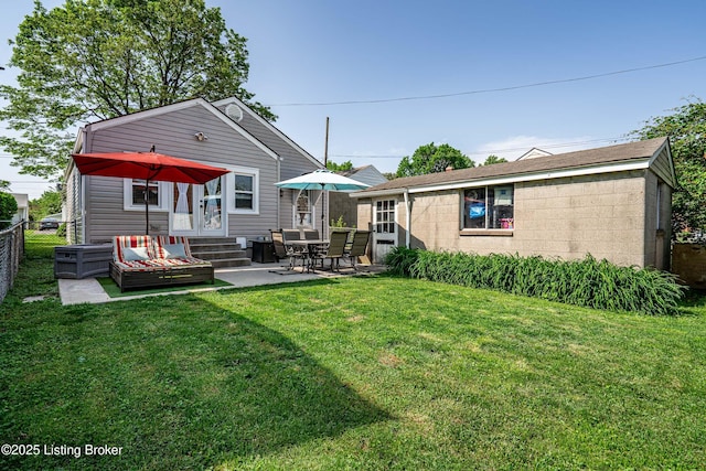 607 Penguin St, Louisville, KY 40217 - rear view of house with entry steps, concrete block siding, a patio, and an outdoor structure