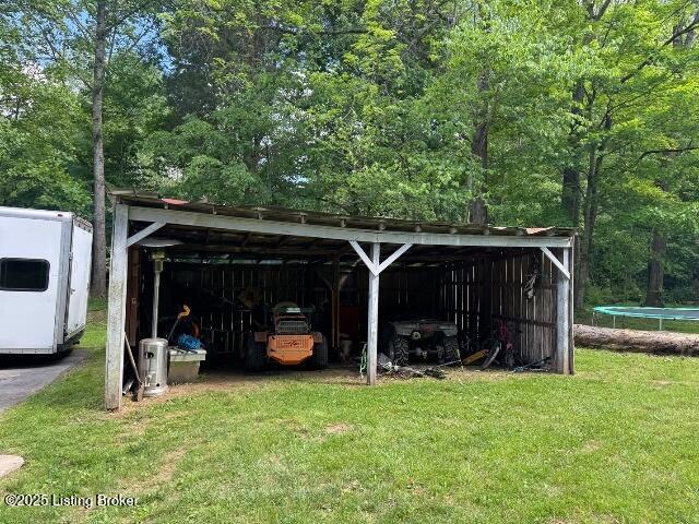 139 Mountain View Estates Rd, Elizabethtown, KY 42701 - view of pole building featuring a trampoline, a carport, and a yard