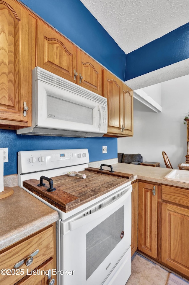 1401 Brooks Hill Rd, Brooks, KY 40109 - kitchen with white appliances, a textured ceiling, brown cabinetry, light countertops, and a sink