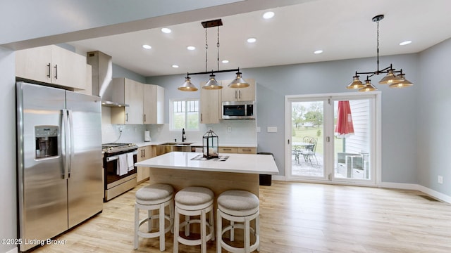 30 Bell Ct, Bedford, KY 40006 - kitchen with appliances with stainless steel finishes, wall chimney exhaust hood, light wood finished floors, light countertops, and recessed lighting