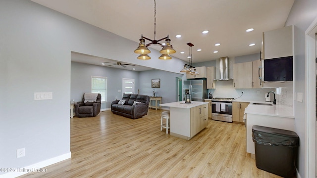 30 Bell Ct, Bedford, KY 40006 - kitchen with stainless steel appliances, wall chimney range hood, a kitchen island, light countertops, and open floor plan