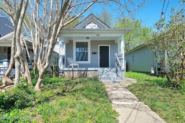 611 E Hill St, Louisville, KY 40217 - shotgun-style home with a porch