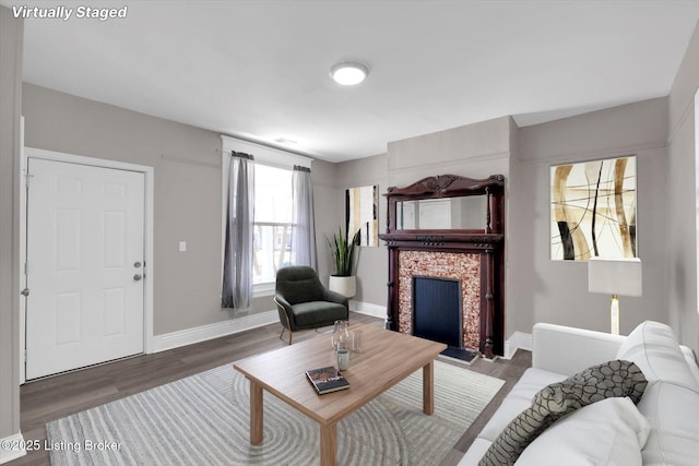 611 E Hill St, Louisville, KY 40217 - living room featuring a tile fireplace, wood finished floors, and baseboards