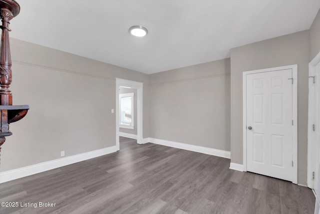 611 E Hill St, Louisville, KY 40217 - spare room featuring baseboards and wood finished floors