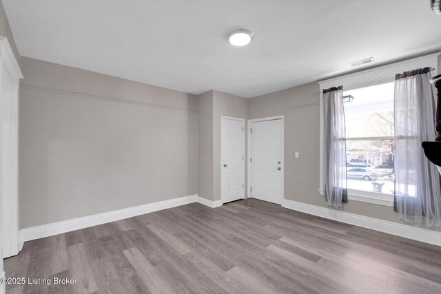 611 E Hill St, Louisville, KY 40217 - unfurnished room with wood finished floors and baseboards