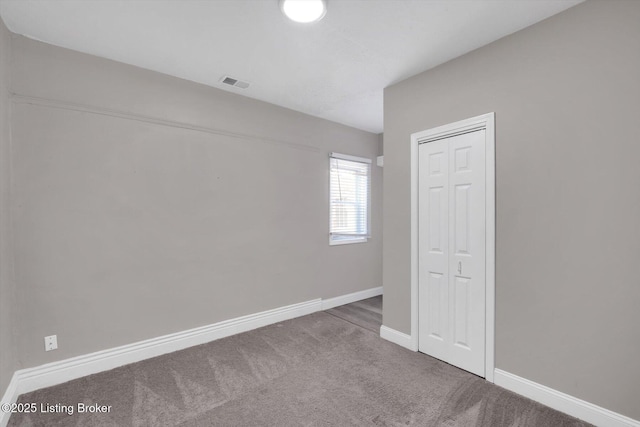 611 E Hill St, Louisville, KY 40217 - empty room with carpet and baseboards