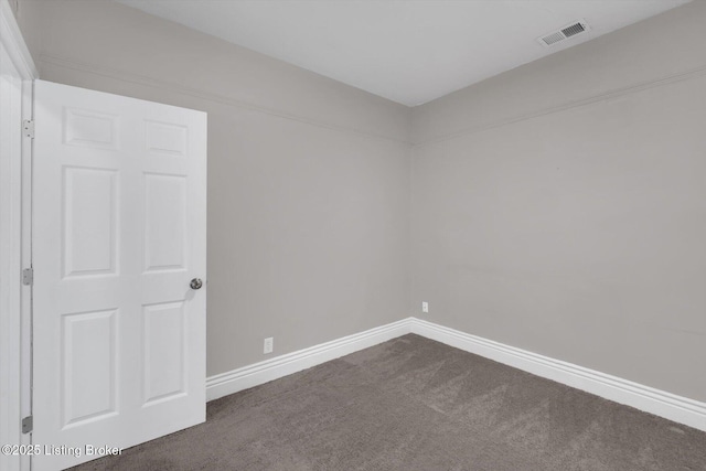 611 E Hill St, Louisville, KY 40217 - spare room featuring dark carpet and baseboards