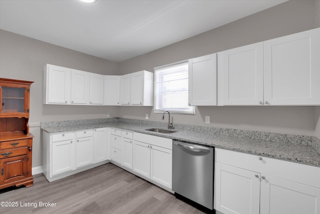 611 E Hill St, Louisville, KY 40217 - kitchen with dishwasher, a sink, light wood-type flooring, and white cabinetry